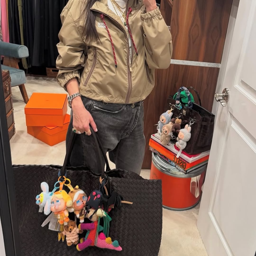 Black woven tote with doll bag charms.