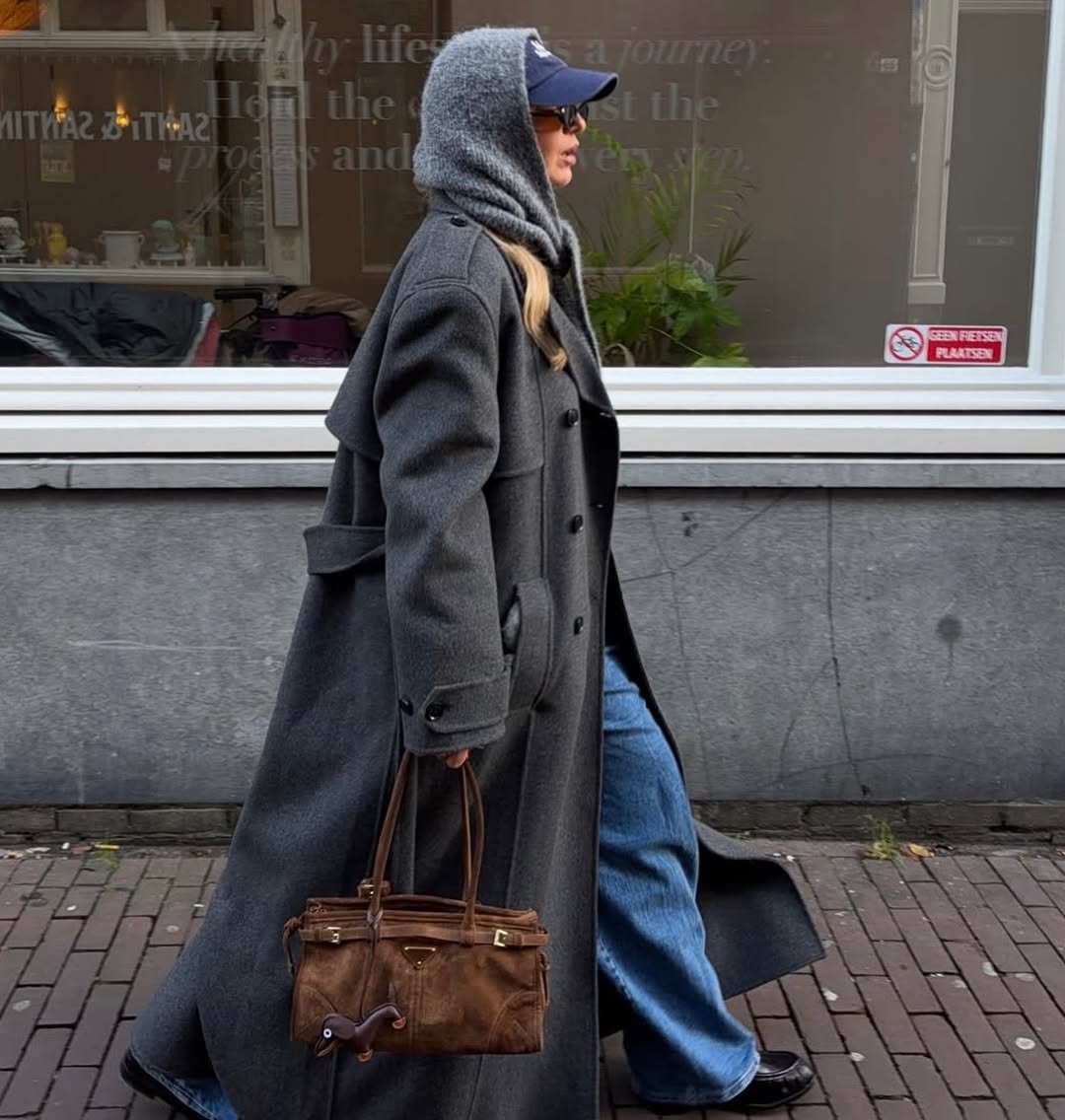 Brown leather handbag with a dog bag charm
