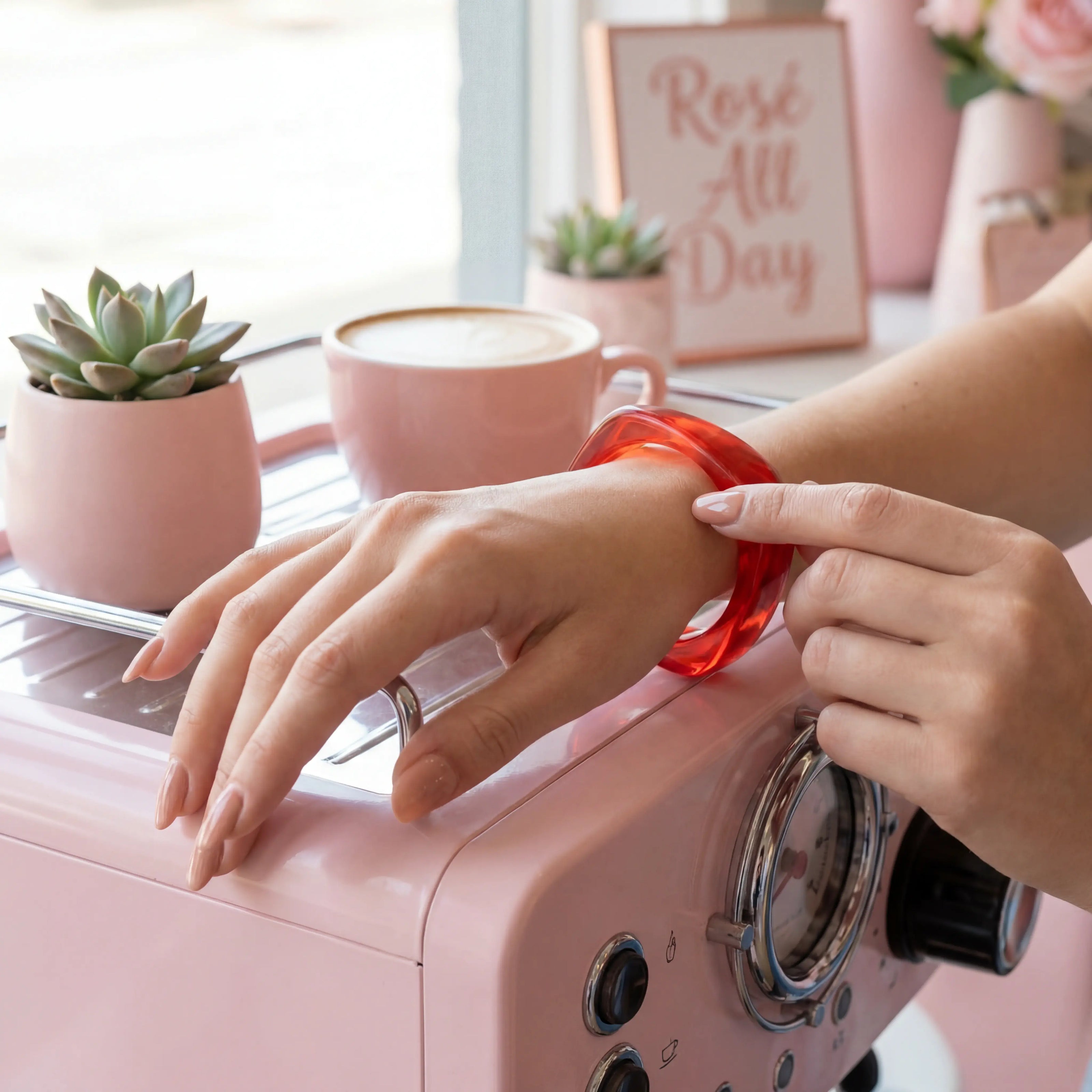 Woman wearing a red bracelet in a café.